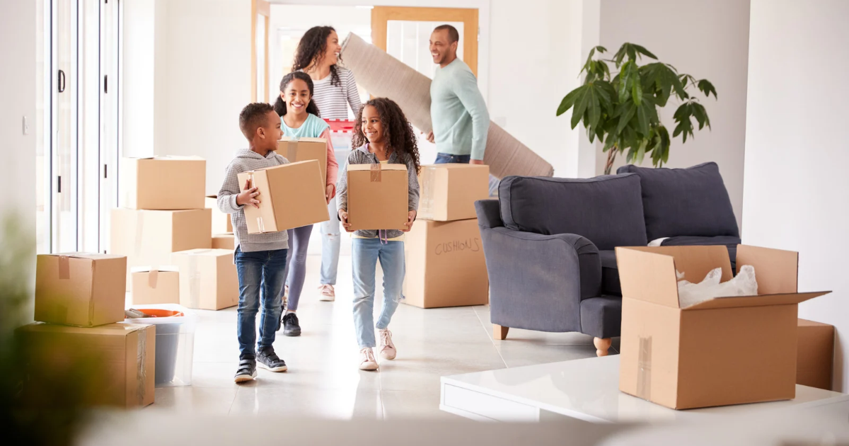 Family carrying moving boxes