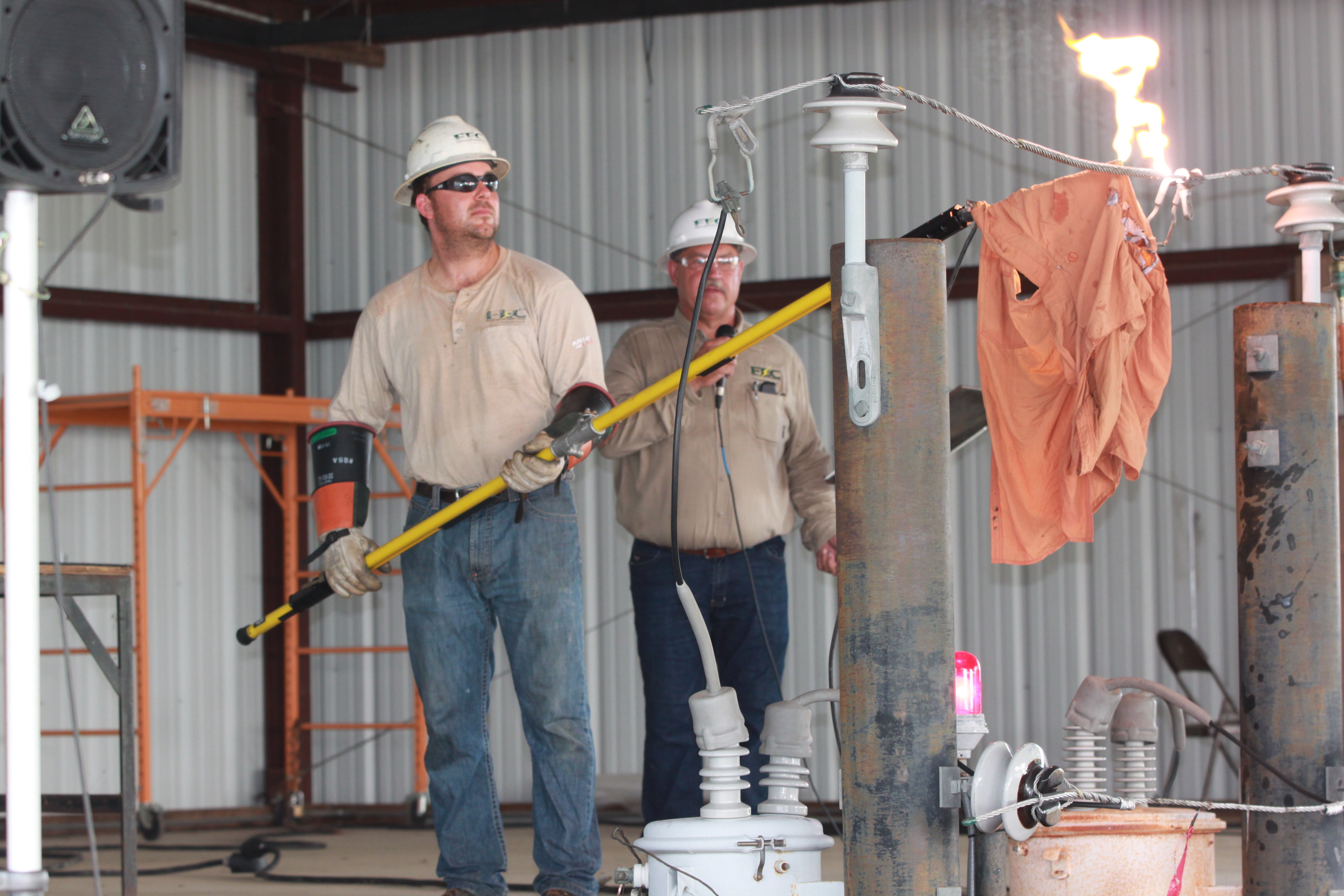 Apprentice Lineman Aaron Tonn demonstrates what happens when clothing touches a powerline